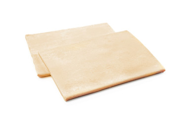 Raw puff pastry on white background