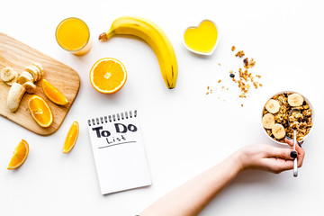 Morning habits of successful people. Healthy breakfast porridge with fruits and planning the day. White background top view copyspace
