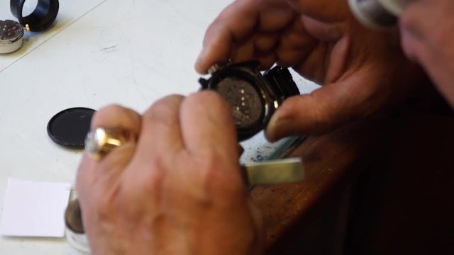 Watchmaker working on the correction of mechanical and quartz watches.