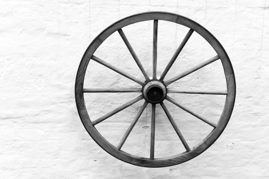 Old wooden cart wheel on the wall
