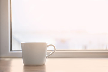Fototapeta na wymiar Ceramic cup on window sill