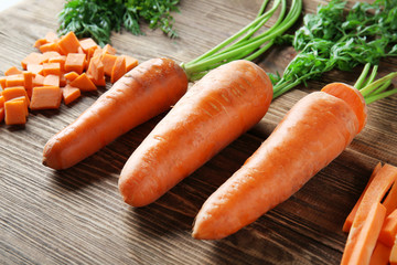 Ripe carrots on wooden background