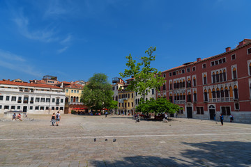 Beautiful venetian street with old houses in a sunny summer day.