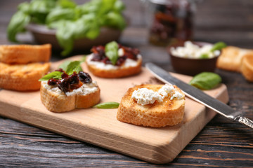 Preparing bruschetta with sun-dried tomatoes, closeup