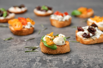 Tasty bruschetta with tomatoes on grey background, closeup