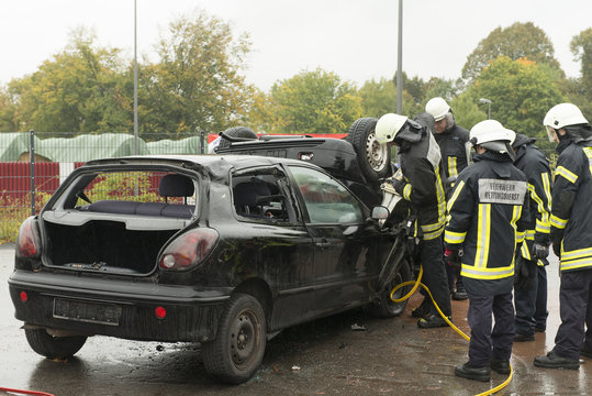 Firemen Rescuing Injured Person from Crashed Car 2
