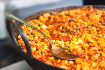 Stewed vegetables in a frying pan (closeup view, shallow depth of field)