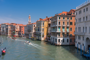 Fototapeta na wymiar Magnificent daily view of Gondola with classical buildings along the famous Grand canal in Venice, Italy