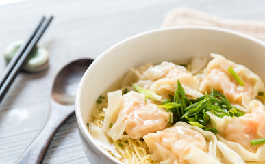Shrimp wonton with braised pork in soup on wooden table - Asian food style, Select focus image