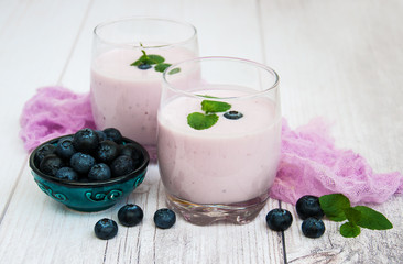 Glasses with blueberry yogurt on a table
