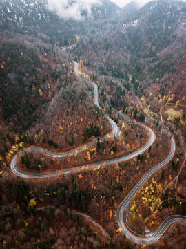 Winding serpentine mountain Road through a german forest during autumn with orange and yellow fall colors