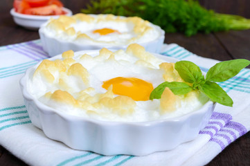 Delicate baked egg Orsini (eggs in the cloud). French breakfast.