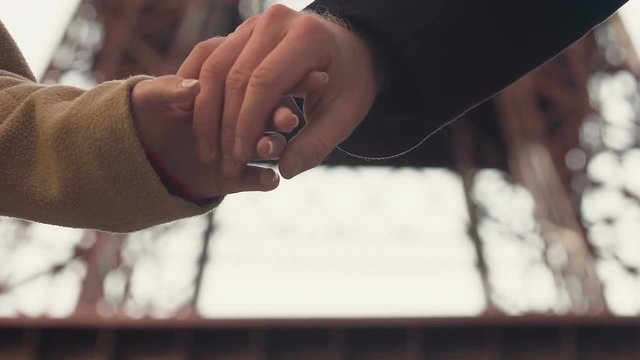 Shy couple holding hands with tender, first date, beginning of love relationship