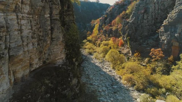 Aerial flight inside a gorge during sunrise or sunset, at Zagorochoria of Northern Greece