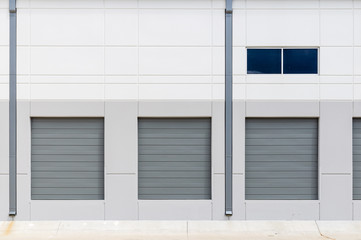 Empty warehouse loading dock white walls gray metal sliding doors