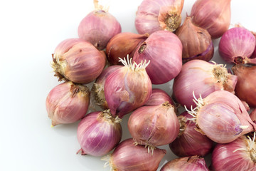 Pile of red onions with root on white background, Thai onions.