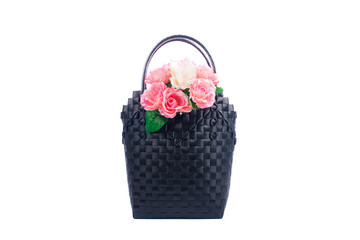 Fototapeta na wymiar black wicker woman's tote bag with flowers, isolated on white background