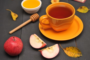 Autumn still life cup of tea, honey and book on the table