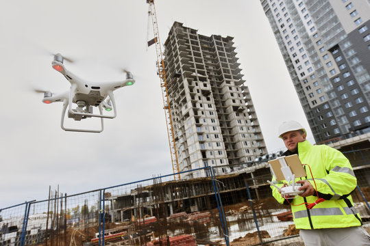 Drone operated by construction worker on building site