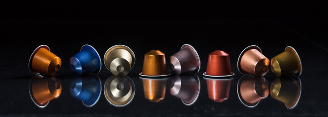 Espresso coffee pods isolated on black background, Closeup view with details, banner