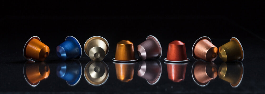 Espresso coffee pods isolated on black background, Closeup view with details, banner