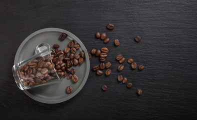Espresso cup and coffee beans on black background, Top view with copy space