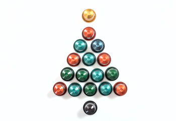 Espresso coffee pods forming a christmas tree, isolated on white background, top view