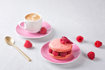 Romantic breakfast with coffee and pink raspberry macaron