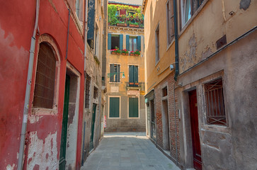 Fototapeta na wymiar Beautiful venetian street with old houses in a sunny summer day.