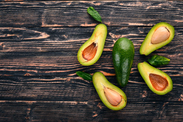 Avocado on a wooden background. Top view. Free space for your text.