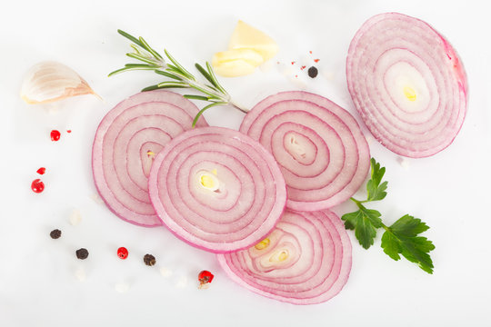 Red onion and spices on white background. Top view.