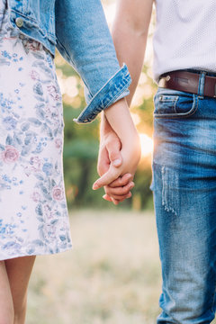 close-up of the hands of a guy and a girl who hold on to each other