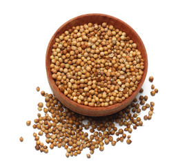 coriander seeds in wooden bowl isolated on white background top view