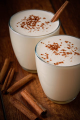 Eggnog houmemade with cinnamon and kakao for Christmas and winter holidays or wooden broun...