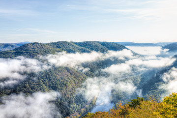 Mountains and fog, mist clouds in morning floating above forest trees, covering, blanketing valley in Grandview Overlook, West Virginia