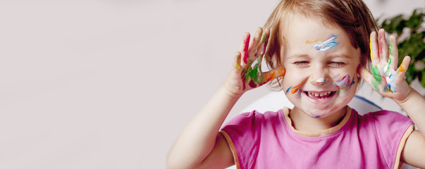 Children's art makeup. Portrait of little beautiful children girl with colored face.