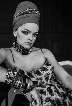 beauty bright african woman with creative make up, shawl on head like cubian closeup