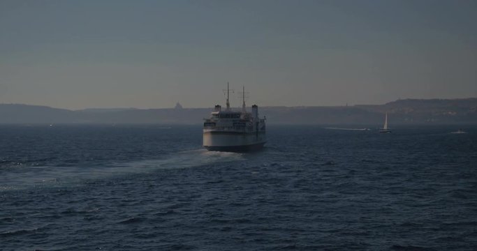 Video shot from a ferry on a sunny day with open sea and ferry in view