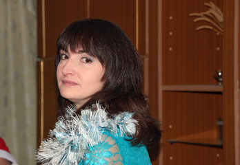 Close-up head and shoulder portrait of mature brunette woman.