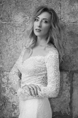 Beautiful bride in a white long dress in a city street