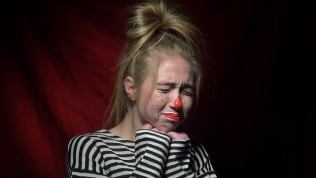 Woman clown shows that she is sad