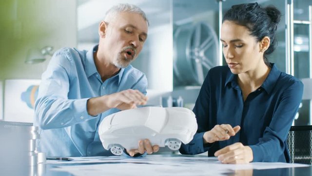 Experienced Automotive Designer and Female Engineer Works with a Concept Car Prototype Model, Perfecting it and Making Design Corrections. Shot on RED EPIC-W 8K Helium Cinema Camera.