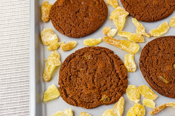 Freshly baked chocolate ginger snap cookies on the baking sheet on a table close-up.