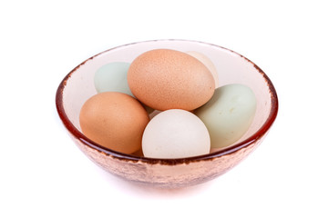 Farm fresh eggs in a bowl on a white background