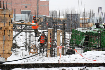 Construction object.The construction of housing. Builders work in the winter, and cold, and snow