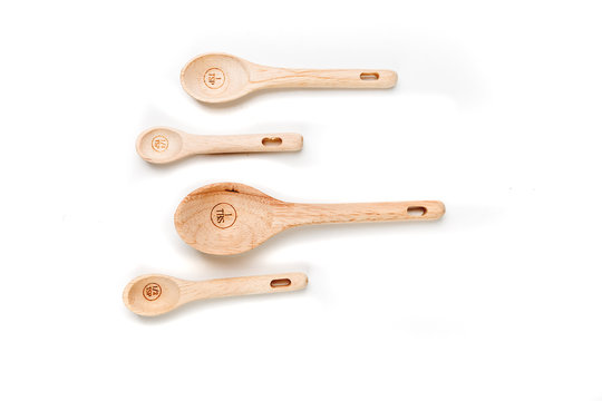 Bamboo measuring spoons on a white background