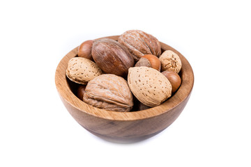 Mixed nuts in shell  in a bowl on a white background