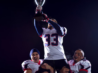 Fototapeta na wymiar american football team with trophy celebrating victory
