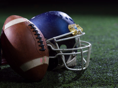closeup of american football and helmet