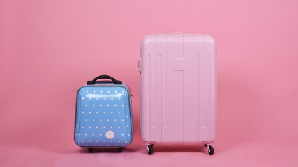 Set of luggage suitcase, Traveler pink suitcase and blue cabin size luggage on pink background, Journey and travel concept.